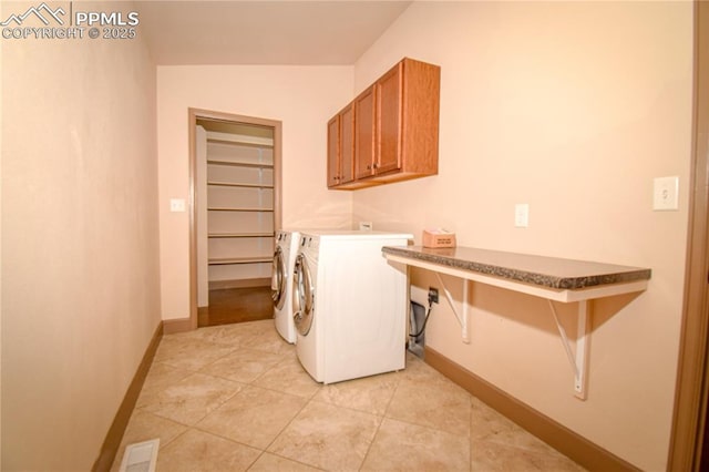 5707 Mark Twain Ln, Pueblo, CO 81008 - washroom featuring cabinet space, washer and clothes dryer, and light tile patterned flooring