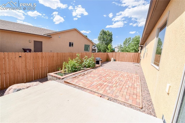 5707 Mark Twain Ln, Pueblo, CO 81008 - fenced backyard featuring a patio and area for grilling