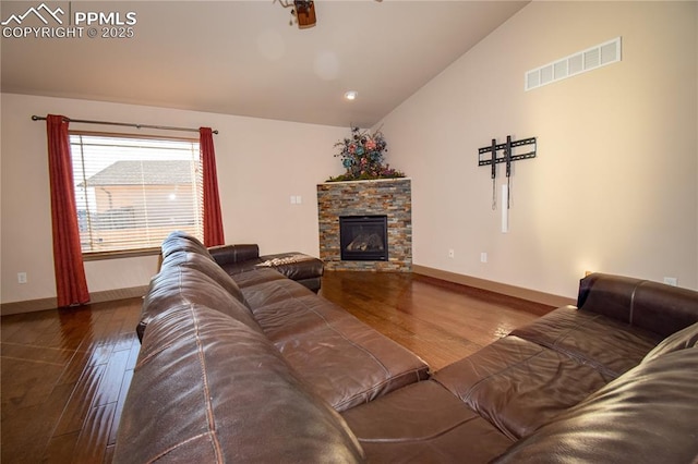 5707 Mark Twain Ln, Pueblo, CO 81008 - living room featuring lofted ceiling, wood finished floors, and a fireplace