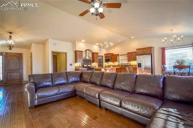 5707 Mark Twain Ln, Pueblo, CO 81008 - living area featuring a chandelier, lofted ceiling, ceiling fan, dark wood finished floors, and plenty of natural light