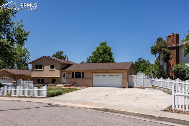 5888 Eldora Dr, Colorado Springs, CO 80918 - view of front of home with a garage, stucco siding, concrete driveway, and a fenced front yard