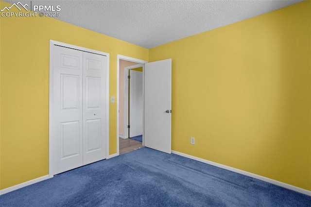 5888 Eldora Dr, Colorado Springs, CO 80918 - unfurnished bedroom featuring dark colored carpet, a closet, and a textured ceiling