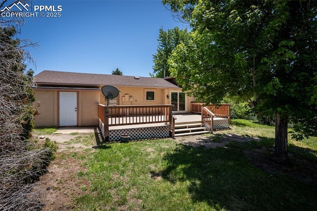 5888 Eldora Dr, Colorado Springs, CO 80918 - rear view of property with stucco siding, a lawn, and a deck