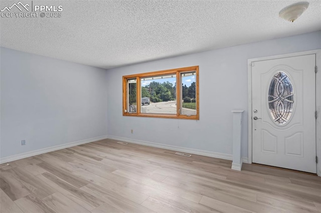5888 Eldora Dr, Colorado Springs, CO 80918 - entryway featuring a textured ceiling and light wood-style flooring