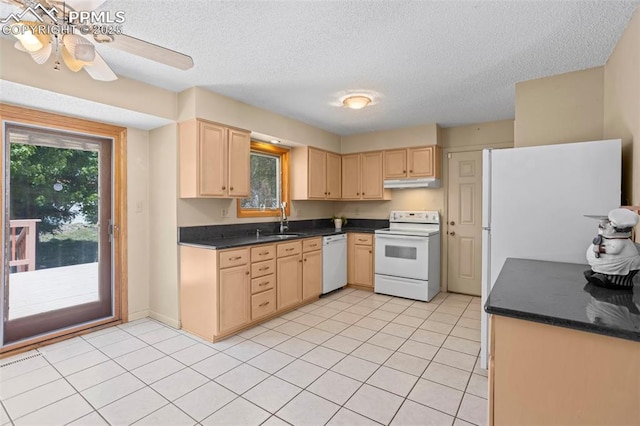 5888 Eldora Dr, Colorado Springs, CO 80918 - kitchen featuring white appliances, under cabinet range hood, light brown cabinets, dark countertops, and a textured ceiling