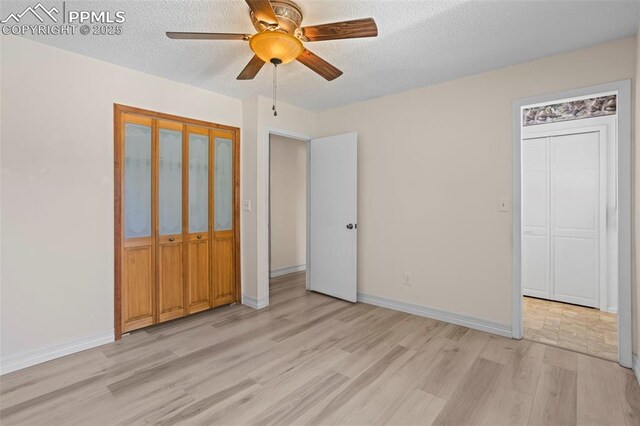 5888 Eldora Dr, Colorado Springs, CO 80918 - unfurnished bedroom with light wood finished floors, a textured ceiling, and ceiling fan