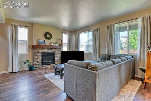 3470 Daydreamer Dr, Colorado Springs, CO 80908 - living room with plenty of natural light, dark wood-style flooring, a fireplace, and a textured ceiling