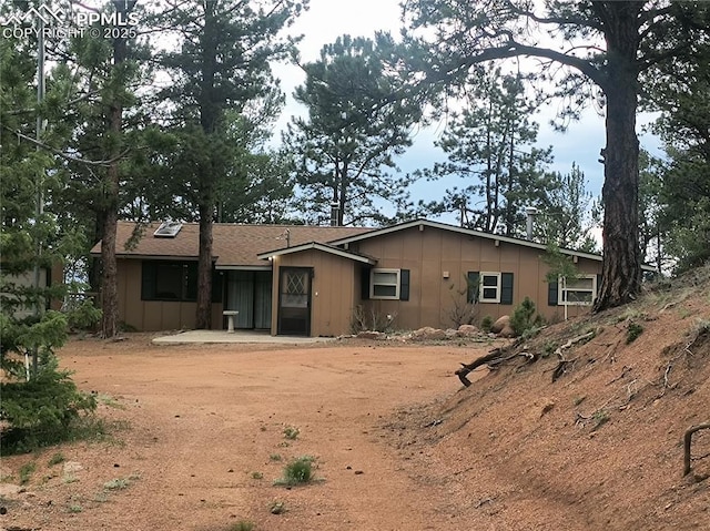 237 Blue Spruce Rd, Divide, CO 80814 - rear view of property with board and batten siding and a patio area