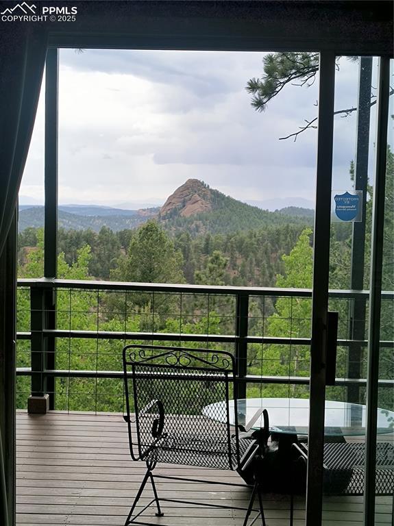 237 Blue Spruce Rd, Divide, CO 80814 - balcony featuring a wooded view and a mountain view