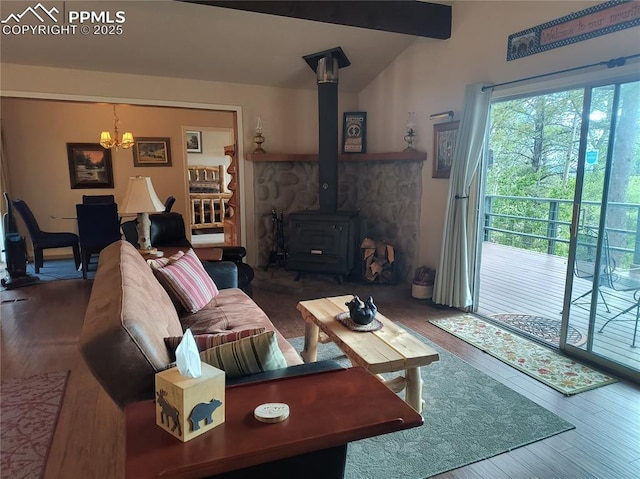 237 Blue Spruce Rd, Divide, CO 80814 - living area with a chandelier, wood finished floors, a wood stove, and vaulted ceiling