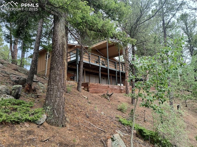 237 Blue Spruce Rd, Divide, CO 80814 - rear view of property featuring a wooden deck and board and batten siding