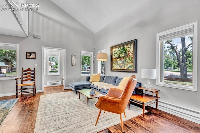 531 N Cedar St, Colorado Springs, CO 80903 - living room featuring a baseboard radiator, healthy amount of natural light, wood finished floors, and high vaulted ceiling