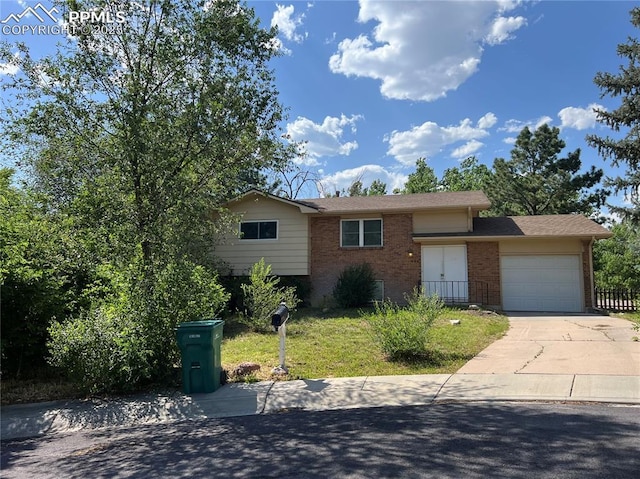 406 Squire St, Colorado Springs, CO 80911 - view of front facade with brick siding, a garage, and concrete driveway
