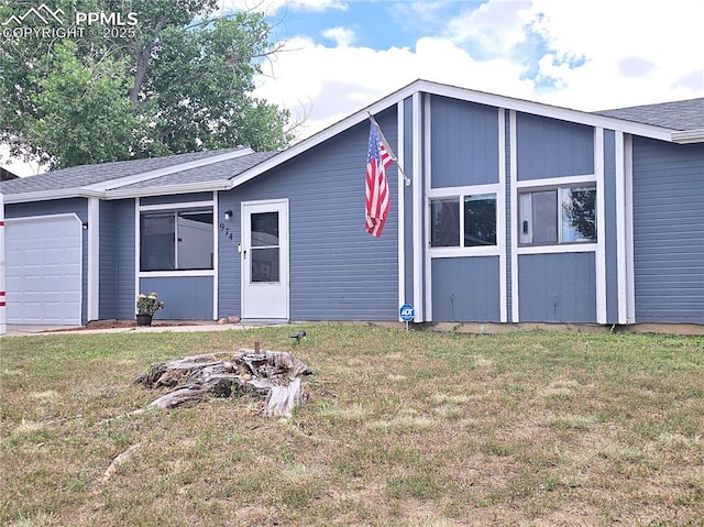 974 S Candlestar Loop, Fountain, CO 80817 - mid-century modern home featuring a garage, a front yard, and a shingled roof
