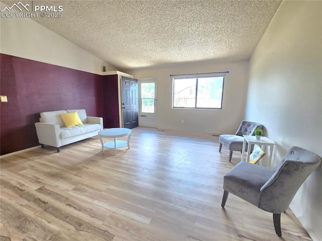 974 S Candlestar Loop, Fountain, CO 80817 - living area with a textured ceiling, wood finished floors, and vaulted ceiling