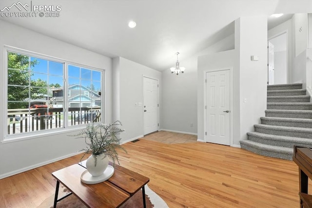 6275 Montarbor Dr, Colorado Springs, CO 80918 - living area with a chandelier, stairs, light wood-style flooring, and lofted ceiling