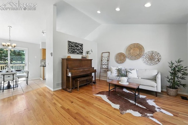 6275 Montarbor Dr, Colorado Springs, CO 80918 - living room with a chandelier, lofted ceiling, light wood finished floors, and recessed lighting