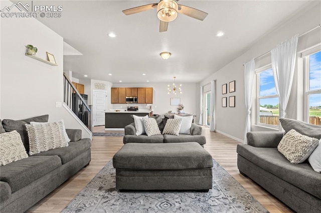 244 S Chipeta Way, Lochbuie, CO 80603 - living area with a chandelier, light wood-style flooring, stairs, recessed lighting, and ceiling fan