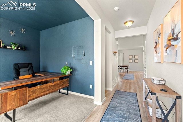 244 S Chipeta Way, Lochbuie, CO 80603 - office area featuring wood finished floors and baseboards
