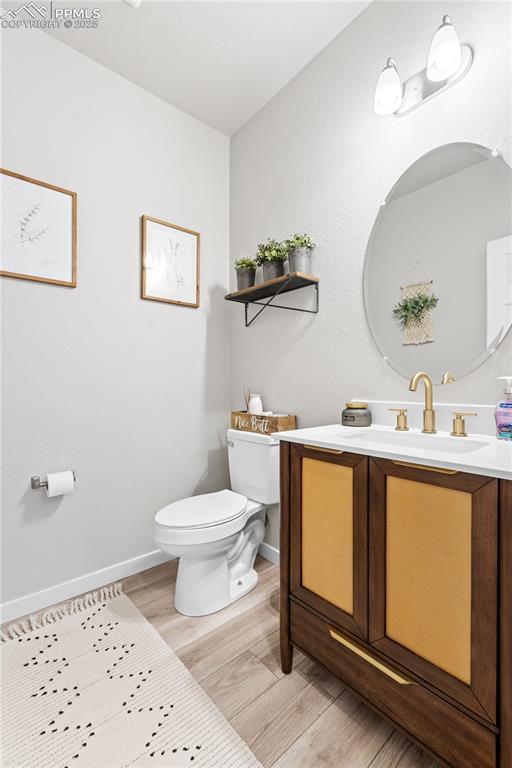 244 S Chipeta Way, Lochbuie, CO 80603 - half bathroom with wood finished floors and vanity