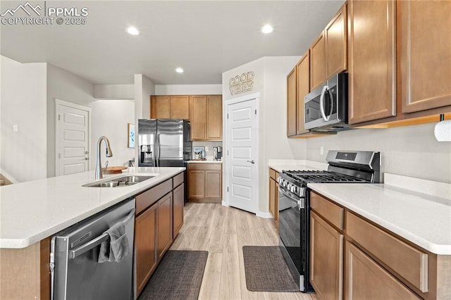 244 S Chipeta Way, Lochbuie, CO 80603 - kitchen with stainless steel appliances, light wood-type flooring, light countertops, recessed lighting, and a center island with sink