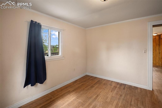 205 N Laurel St, Woodland Park, CO 80863 - spare room featuring hardwood / wood-style flooring and ornamental molding