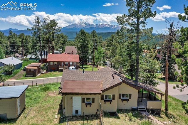205 N Laurel St, Woodland Park, CO 80863 - back of house featuring a mountain view, stucco siding, and a shingled roof