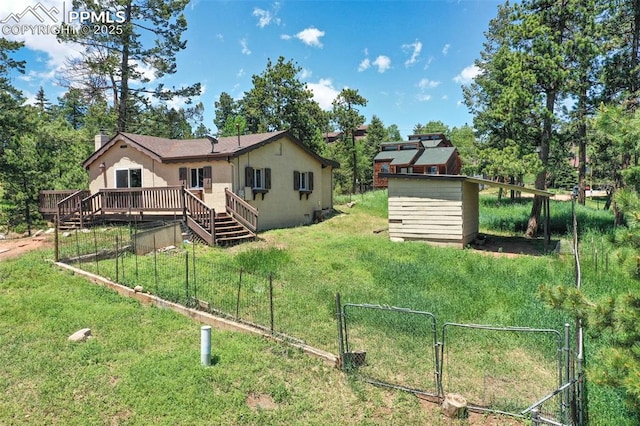 205 N Laurel St, Woodland Park, CO 80863 - back of house featuring a gate, a deck, and view of wooded area