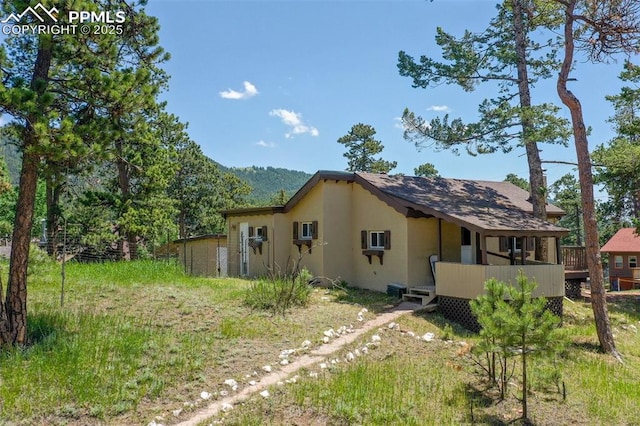205 N Laurel St, Woodland Park, CO 80863 - view of home's exterior with stucco siding and a deck