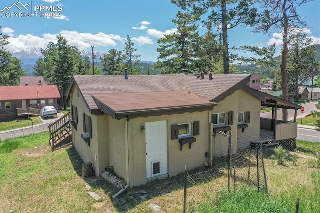 205 N Laurel St, Woodland Park, CO 80863 - back of property with stucco siding and roof with shingles