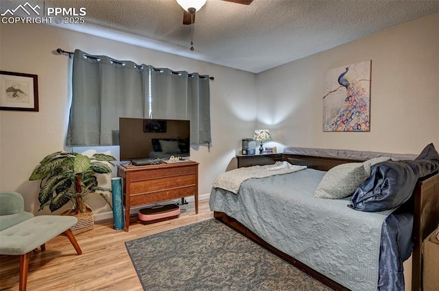 1222 Hartford St, Colorado Springs, CO 80906 - bedroom with wood finished floors, a textured ceiling, and a ceiling fan