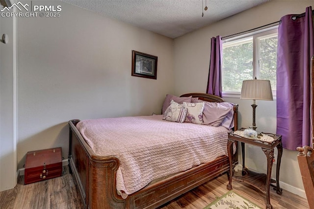 1222 Hartford St, Colorado Springs, CO 80906 - bedroom featuring a textured ceiling and wood finished floors