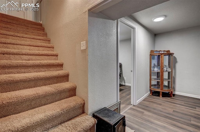 1222 Hartford St, Colorado Springs, CO 80906 - stairs with wood finished floors and a textured wall
