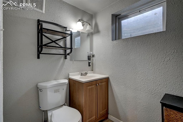 1222 Hartford St, Colorado Springs, CO 80906 - half bathroom featuring vanity and a textured wall