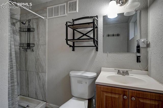 1222 Hartford St, Colorado Springs, CO 80906 - full bath featuring vanity, a textured wall, and a tile shower