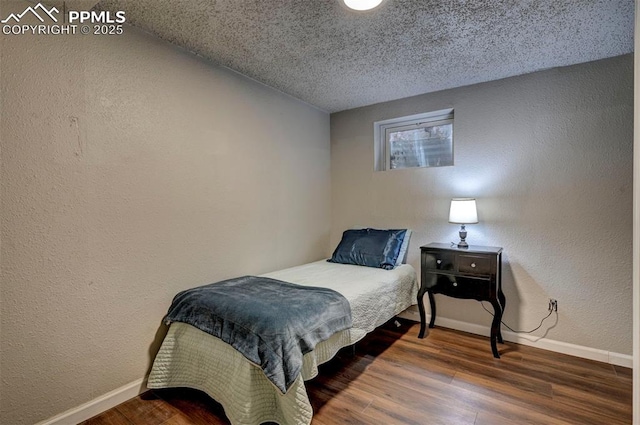 1222 Hartford St, Colorado Springs, CO 80906 - bedroom with wood finished floors, a textured wall, and a textured ceiling