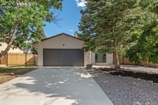 4615 Anjelina Cir, Colorado Springs, CO 80916 - view of front of home featuring a garage, driveway, and a chimney
