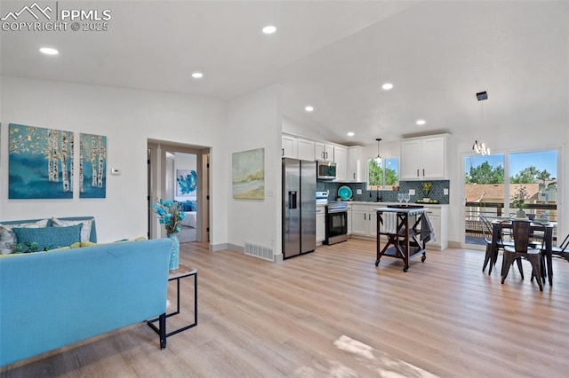 4615 Anjelina Cir, Colorado Springs, CO 80916 - living area featuring light wood-style floors, recessed lighting, and lofted ceiling