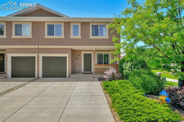 2601 Lynbarton Pt, Colorado Springs, CO 80918 - view of property with stucco siding, concrete driveway, and an attached garage