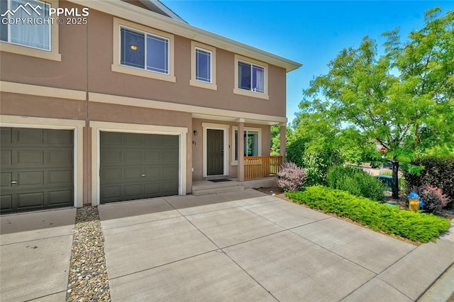 2601 Lynbarton Pt, Colorado Springs, CO 80918 - view of property with stucco siding, covered porch, concrete driveway, and an attached garage