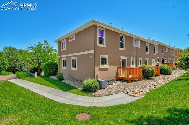 2601 Lynbarton Pt, Colorado Springs, CO 80918 - back of property featuring stucco siding, a lawn, and a wooden deck