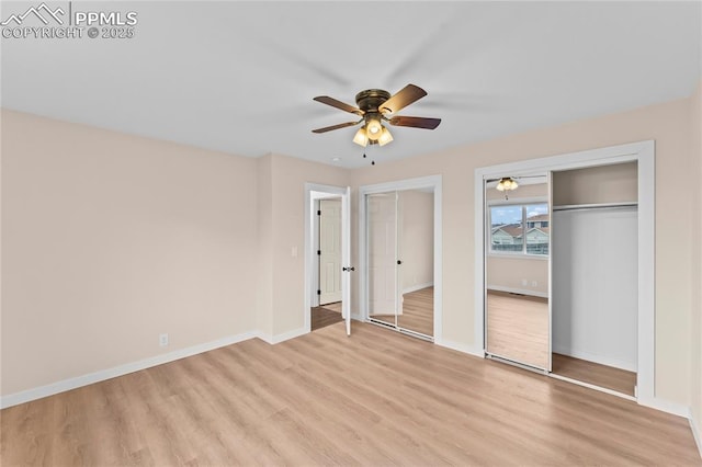 1005 Mountain View Rd, Woodland Park, CO 80863 - unfurnished bedroom featuring two closets, light wood-style floors, and ceiling fan