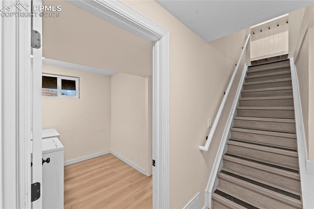 1005 Mountain View Rd, Woodland Park, CO 80863 - stairs featuring washer and clothes dryer and wood finished floors