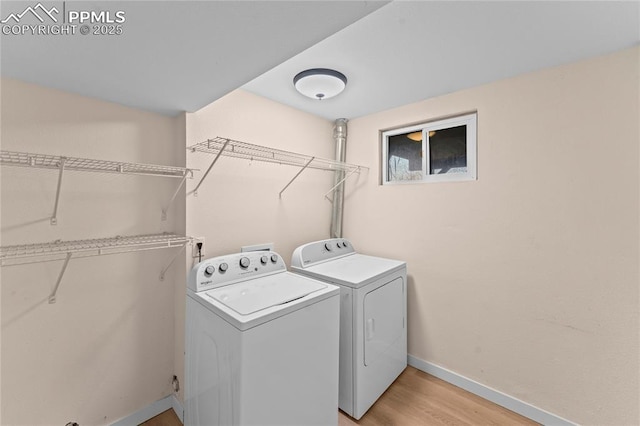 1005 Mountain View Rd, Woodland Park, CO 80863 - washroom featuring washer and dryer and light wood-style floors