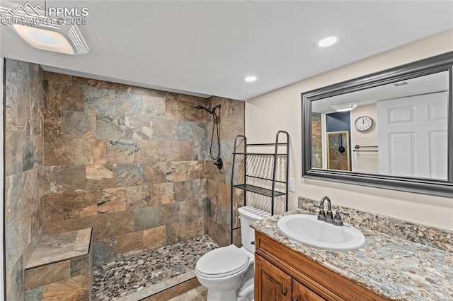 1005 Mountain View Rd, Woodland Park, CO 80863 - bathroom featuring tiled shower, vanity, and recessed lighting