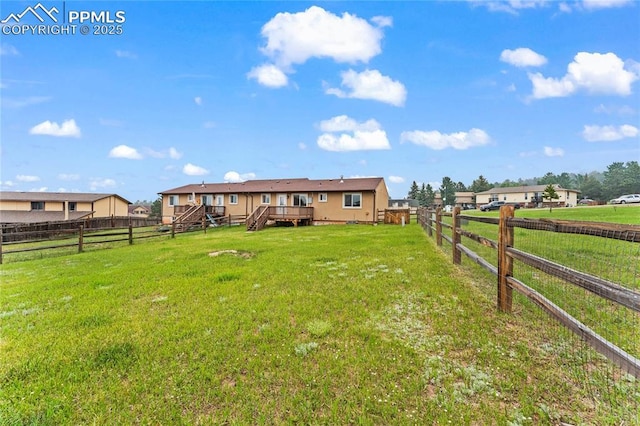 1005 Mountain View Rd, Woodland Park, CO 80863 - fenced backyard featuring a wooden deck and stairway