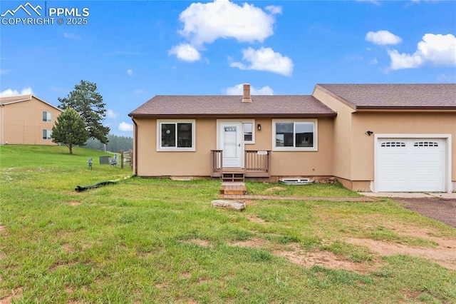 1005 Mountain View Rd, Woodland Park, CO 80863 - view of front of home with a garage, a front yard, stucco siding, and driveway
