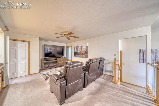 1520 Ledge Rock Ter, Colorado Springs, CO 80919 - home theater room with a textured ceiling, a ceiling fan, and carpet
