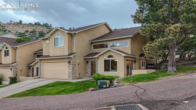 1520 Ledge Rock Ter, Colorado Springs, CO 80919 - multi unit property featuring stucco siding, an attached garage, driveway, and stone siding