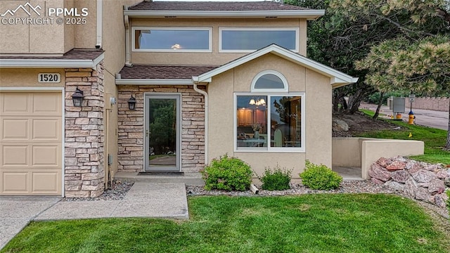 1520 Ledge Rock Ter, Colorado Springs, CO 80919 - property entrance featuring stucco siding, stone siding, a lawn, a shingled roof, and a garage